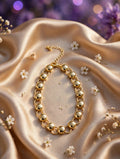 Pulsera círculos enlazados con esferas doradas